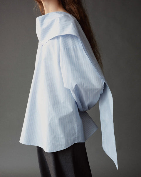 Mijeong Park Tie Neck Blouse - Side View Highlighting Relaxed Fit Silhouette in Light Blue Cotton