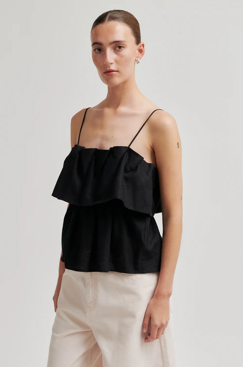 Second Female Aie Top Black - Close-Up of Frilled Bust Detail and Linen Texture