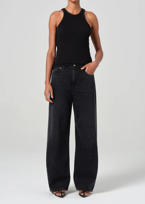 mid-rise fit black denim with a subtle, curved outseam that gently tapers for a flattering silhouette.