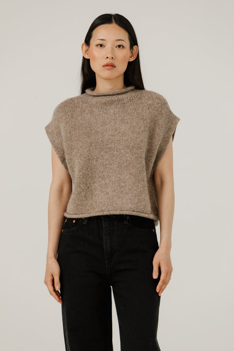 Sweater vest in beige, boxy fit, hits at waist, made of merino wool and has a mock neckline, brand is Bare Knitwear