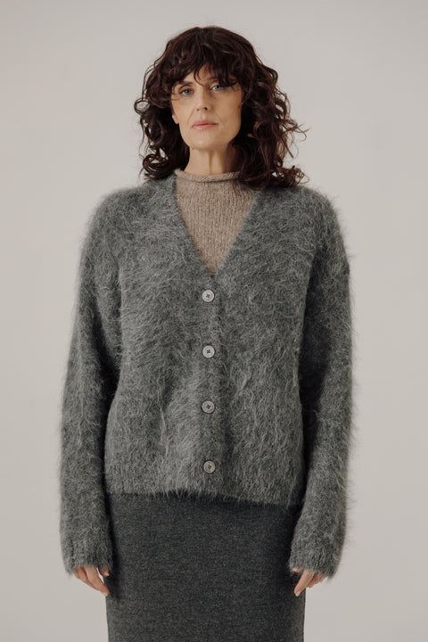 V neck cardigan in stone grey, classic boxy fit, light grey buttons. Brand is Bare Knitwear