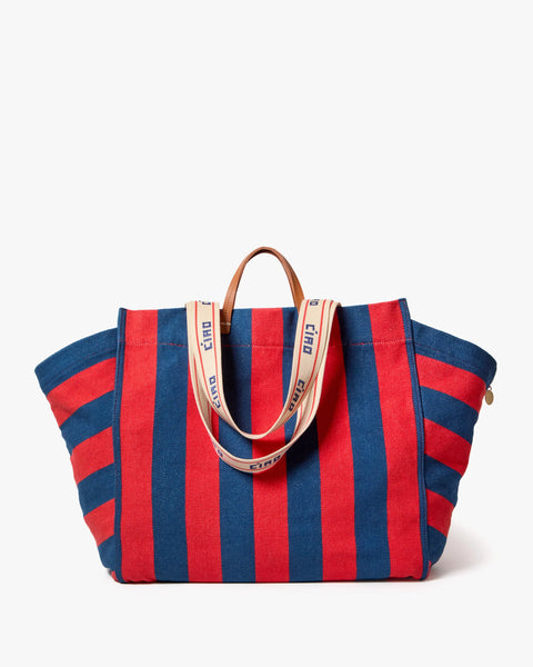 100% cotton canvas tote bad, in blue and red stripe. oversized bag with a dual- top and shoulder strap and an interior pocket.
