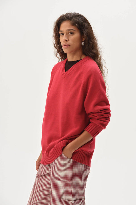 Red v neck cotton sweater angled front view relaxed silhouette