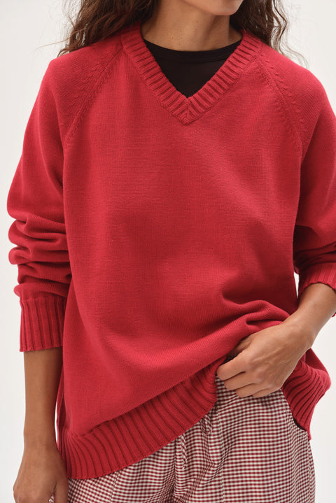 Red cotton knit sweater close up v neck ribbed detail