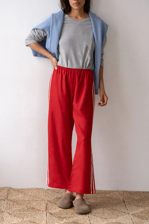 lightweight linen cropped pants in red with double white strip down the leg. Elastic waistband and cropped inseam and a wide leg fit.