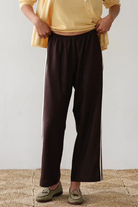 DONNI lightweight linen cropped pants in brown with double white strip down the leg. Elastic waistband and cropped inseam and a wide leg fit.