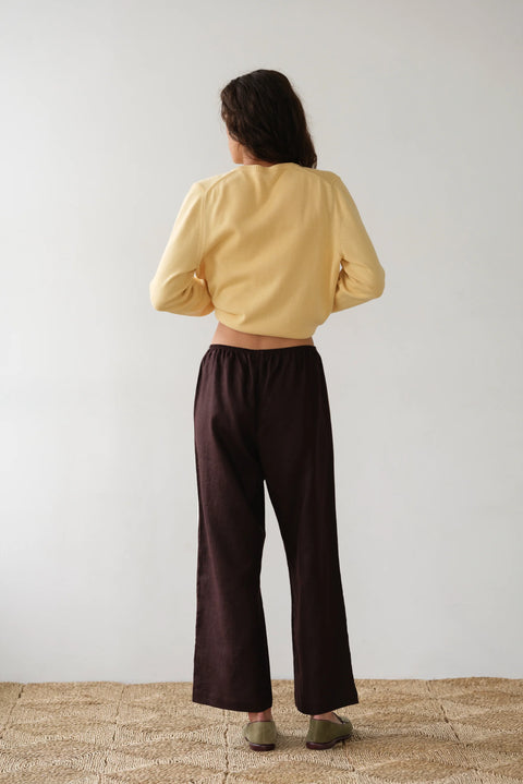 DONNI lightweight linen cropped pants in brown with double white strip down the leg. Elastic waistband and cropped inseam and a wide leg fit.