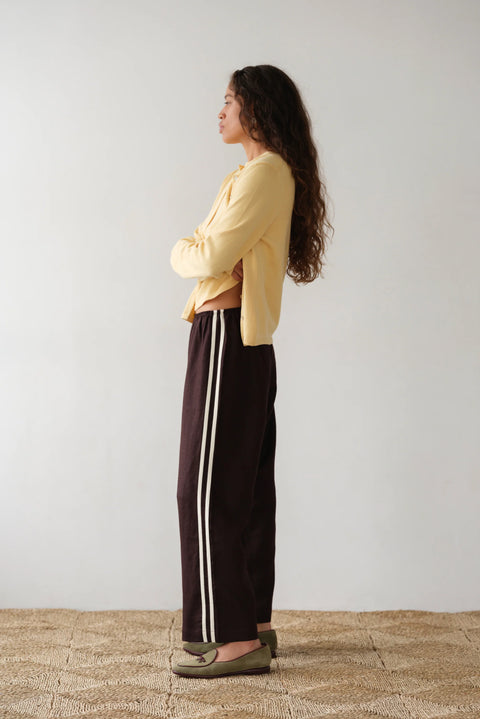 DONNI lightweight linen cropped pants in brown with double white strip down the leg. Elastic waistband and cropped inseam and a wide leg fit.