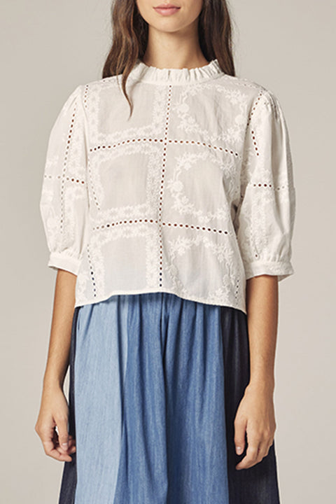 White eyelet cotton blouse front view styled.