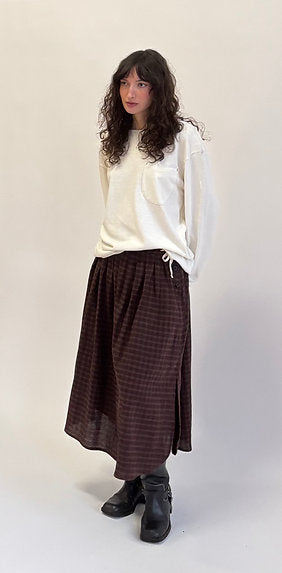 midi length skirt with a slightly curved hem and side slit, finished with side-seam pockets and a contrast waist tie for comfort and the perfect fit