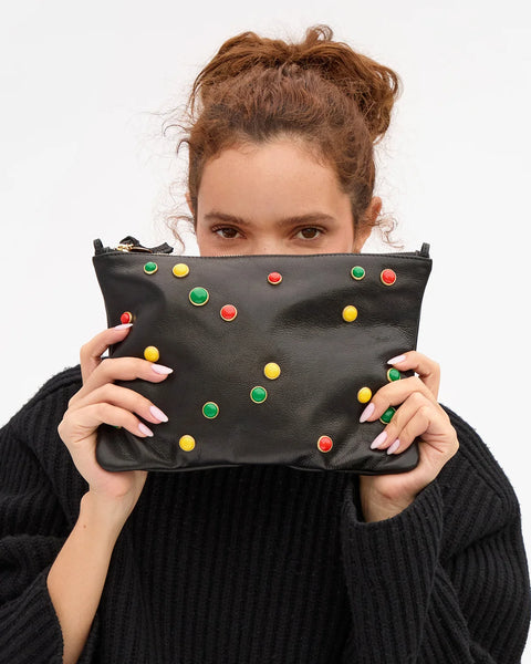 Clare V Flat Clutch with Tabs in Black leather with Bonbon Studs – styled on model as shoulder bag