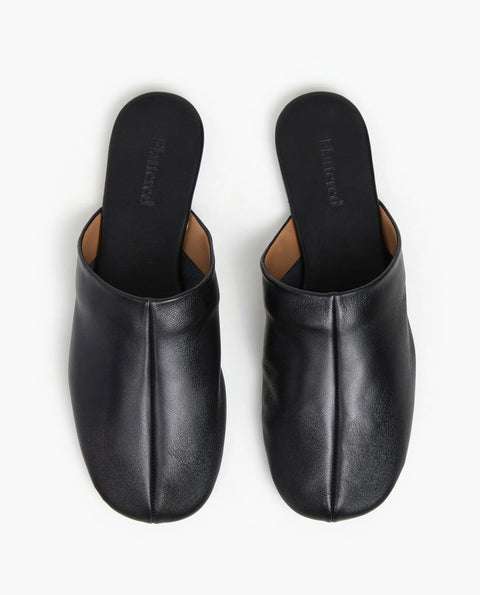 Soft leather black slide, rubber sole, chic slides are bisected with a clean seam through the upper