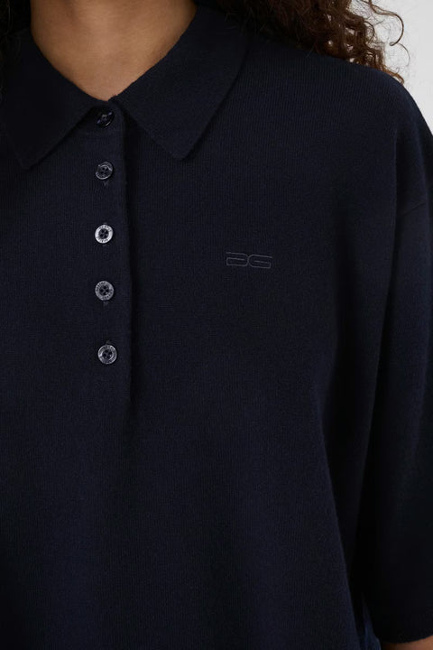 Black wool knit polo shirt with a boxy silhouette, dropped shoulders, five-button placket, and elbow-length wide sleeves.