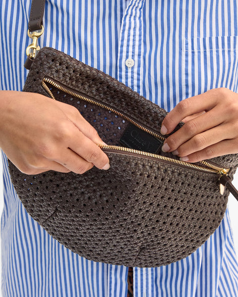 Clare V Grande Fanny in chocolate rattan styled as a crossbody bag – versatile designer belt bag worn over shoulder