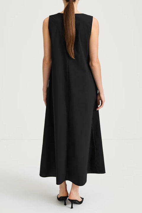 back view of the Jaisie Dress, a soft cotton blend midi dress featuring a U-neckline and gentle gathering for a flowing silhouette.