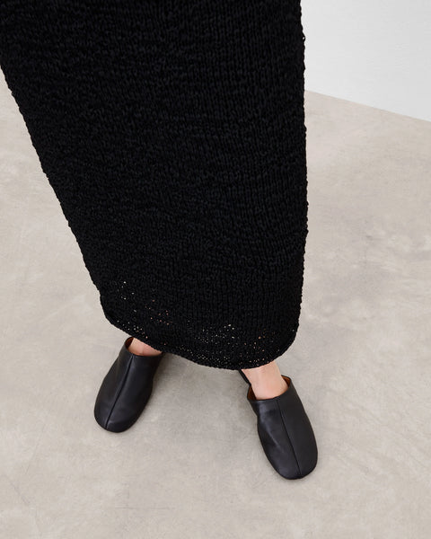 Soft leather black slide, rubber sole, chic slides are bisected with a clean seam through the upper