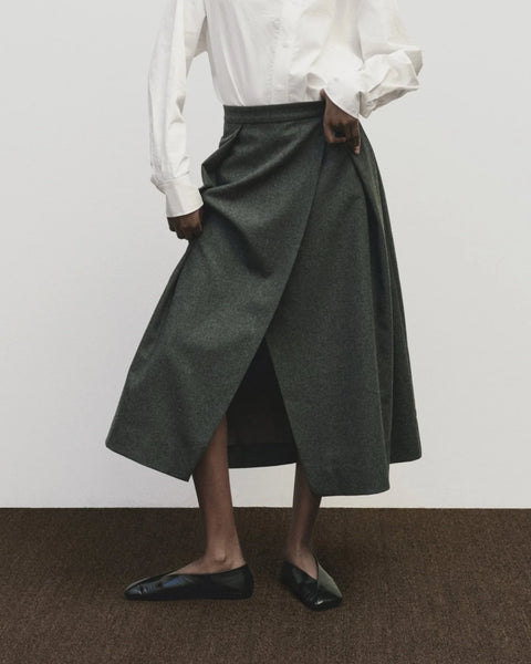 Wool long skirt. Pleated skirt by Mijeong Park. Classic kilt and elongates it to the ankle with an a-line silhouette and pleated, wrap-front detail. Fully lined