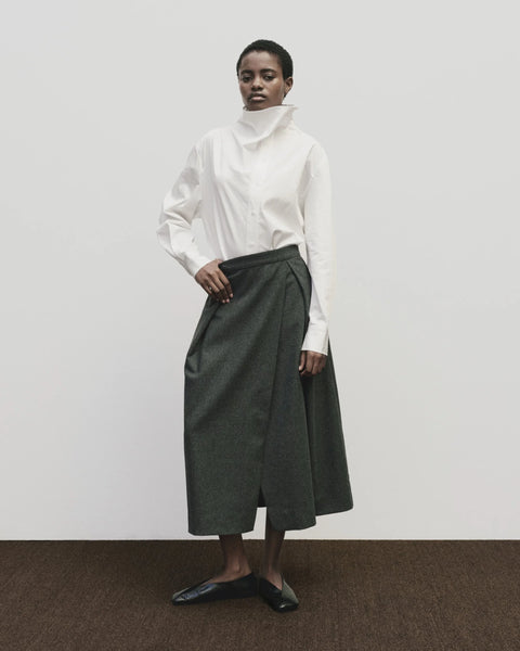 Wool long skirt. Pleated skirt by Mijeong Park. Classic kilt and elongates it to the ankle with an a-line silhouette and pleated, wrap-front detail. Fully lined