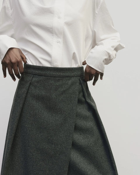 Wool long skirt. Pleated skirt by Mijeong Park. Classic kilt and elongates it to the ankle with an a-line silhouette and pleated, wrap-front detail. Fully lined
