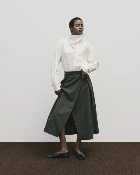 Wool long skirt. Pleated skirt by Mijeong Park. Classic kilt and elongates it to the ankle with an a-line silhouette and pleated, wrap-front detail. Fully lined