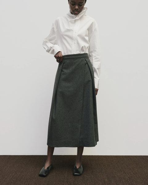 Wool long skirt. Pleated skirt by Mijeong Park. Classic kilt and elongates it to the ankle with an a-line silhouette and pleated, wrap-front detail. Fully lined