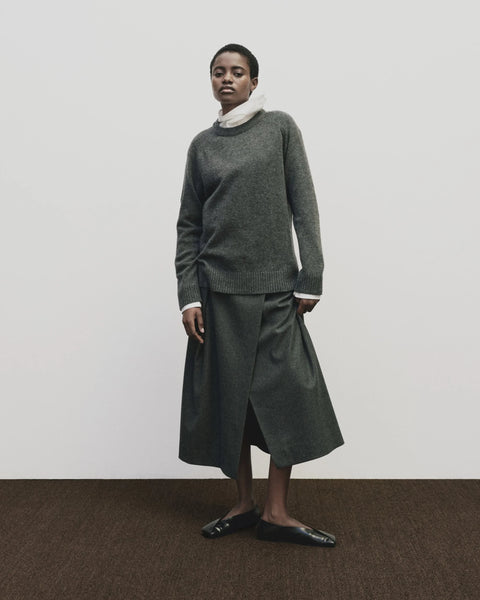 Wool long skirt. Pleated skirt by Mijeong Park. Classic kilt and elongates it to the ankle with an a-line silhouette and pleated, wrap-front detail. Fully lined