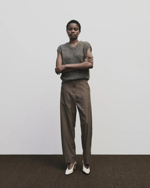 Relaxed fit pants with straight leg and oversized pockets. Buttons on the waist and cuff for adjustability. Trouser by Mijeong Park