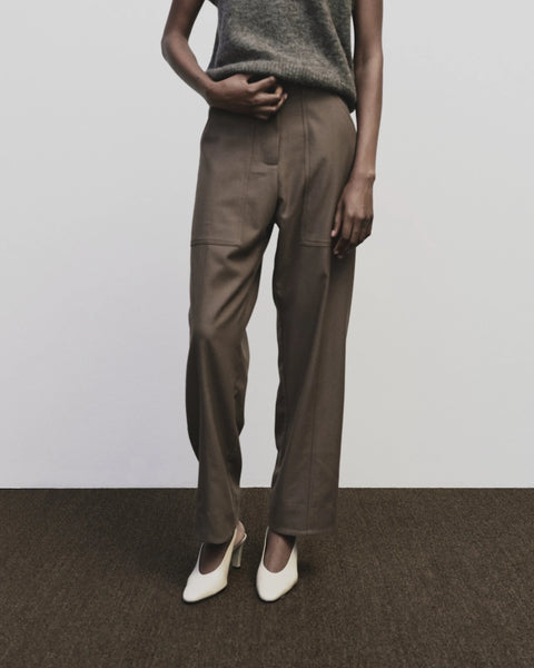 Relaxed fit pants with straight leg and oversized pockets. Buttons on the waist and cuff for adjustability. Trouser by Mijeong Park