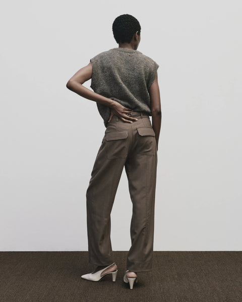Relaxed fit pants with straight leg and oversized pockets. Buttons on the waist and cuff for adjustability. Trouser by Mijeong Park