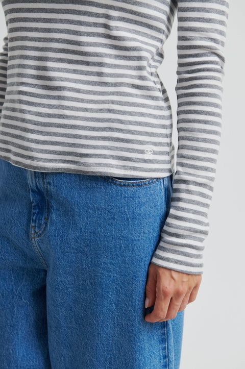 A grey and white striped long sleeve t-shirt by Second Female, featuring a round neckline, twin needle stitching, and a flattering close-fit silhouette crafted from 100% cotton.