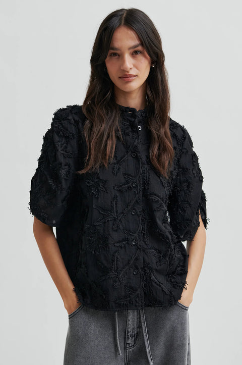 Textured leaf pattern short sleeve cotton sweater in black, button-through placket, and short sleeves with an elastic, ruched detail.