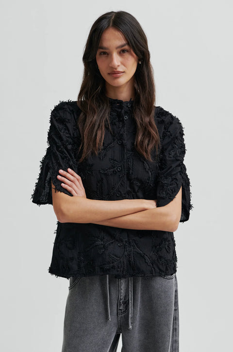 Textured leaf pattern short sleeve cotton sweater in black, button-through placket, and short sleeves with an elastic, ruched detail.