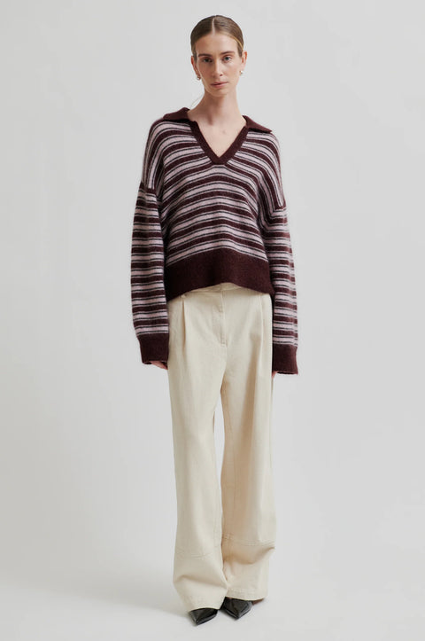Knit sweater with stripes and a v-neck polo collar. Made of mohair and has a fuzzy texture. Relaxed fit true to size