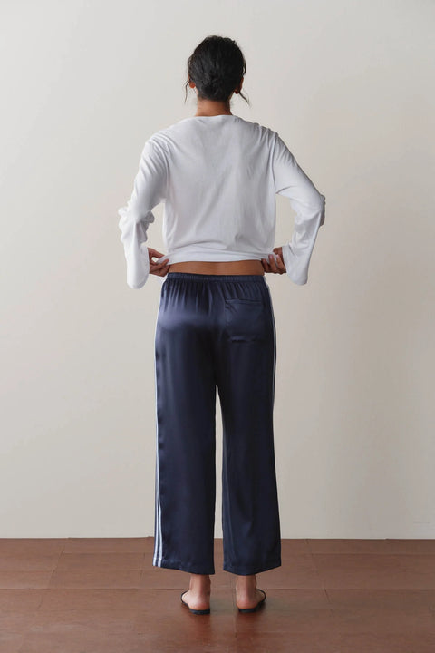 DONNI Silk Crop Pant Navy Cloud - Side View Highlighting Elegant Silk Charmeuse Drape and Cropped Silhouette