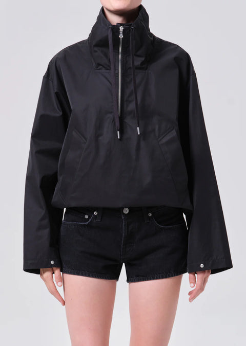 AGOLDE Lydia anorak in black, featuring a three-quarter zip, high collar, and a relaxed cropped fit in breathable lightweight nylon.
