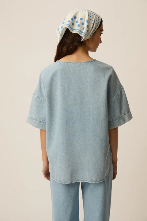 Des Petits Hauts Loris oversized denim t-shirt in bleached blue cotton with a relaxed fit and shirttail hem.