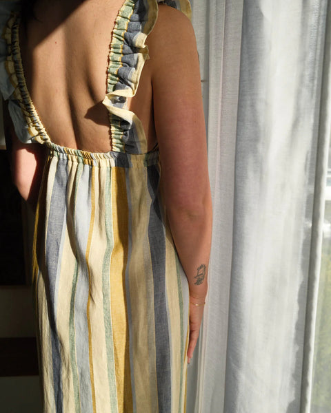 The Milos dress in a linen-cotton blend, featuring a vintage-inspired silhouette with a supportive, stretchy elastic bust designed to be worn braless.