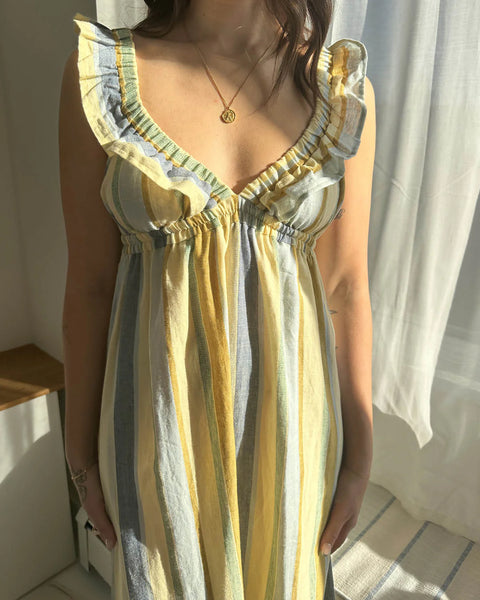 The Milos dress in a linen-cotton blend, featuring a vintage-inspired silhouette with a supportive, stretchy elastic bust designed to be worn braless.