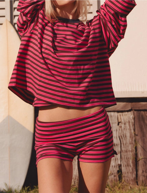 Front view of Apres June pink and brown stripe long sleeve tee – easy oversized summer layering top with rolled sleeve detail