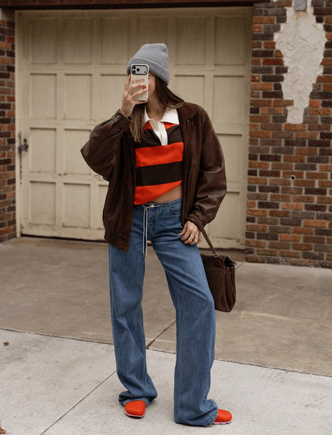 100% cashmere rugby long sleeve shirt with orange and brown stripes and a white collar. 
