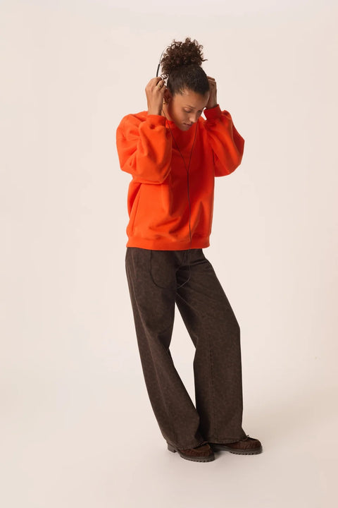 Des Petits Hauts Joeme Orange Sweatshirt - Styled Shot with Jeans Showing Casual Bold Colour Look
