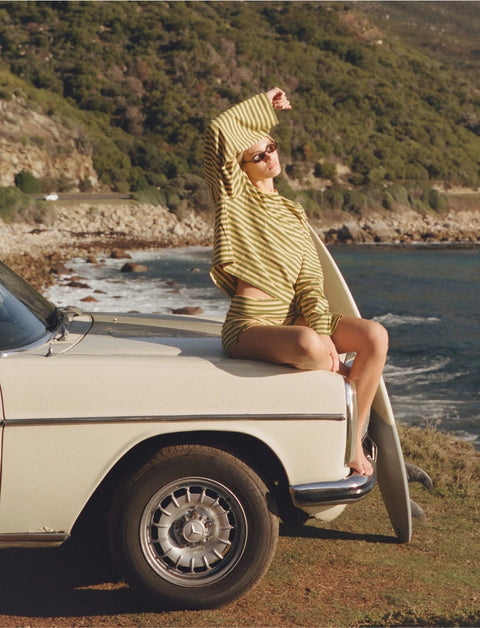 Side view of Apres June melon stripe long sleeve tee showing dropped shoulder and extra-long rolled sleeve