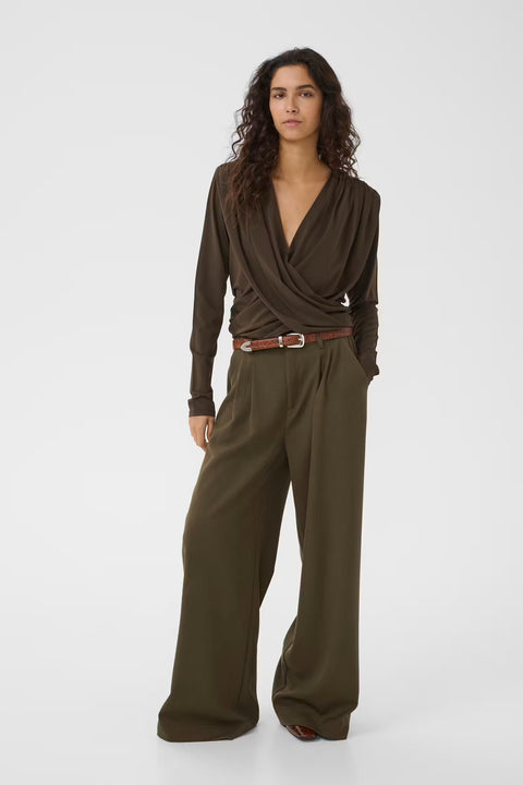 Gestuz Josefi Top — close-up of shoulder pad and plunging wrap neckline detail