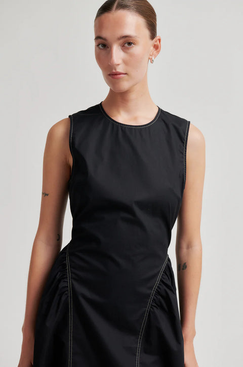 Second Female Larkini Black Dress - Front View Showing Slim Bodice and Sculptured Gathered Hip Detail