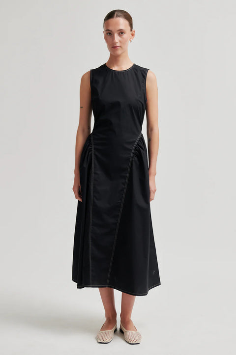 Second Female Black Organic Cotton Dress - Side View Highlighting Flared Skirt and Structured Silhouette