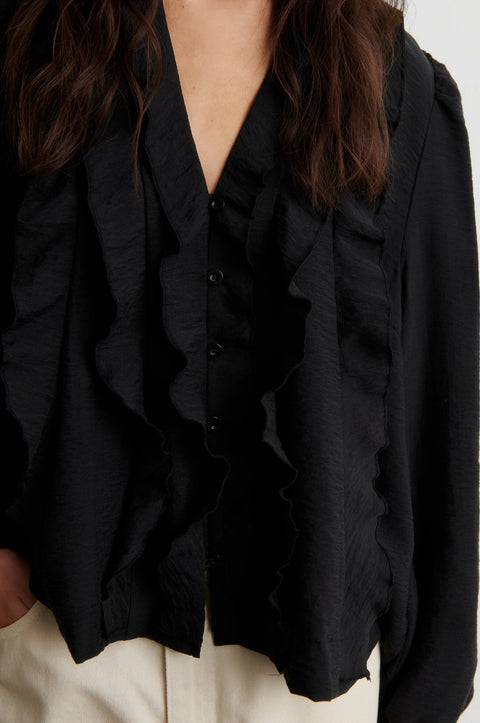 Second Female Rayna Black Frill Blouse - Front View Showing Ruffle Front Detailing and Long Sleeve Crinkled Lyocell