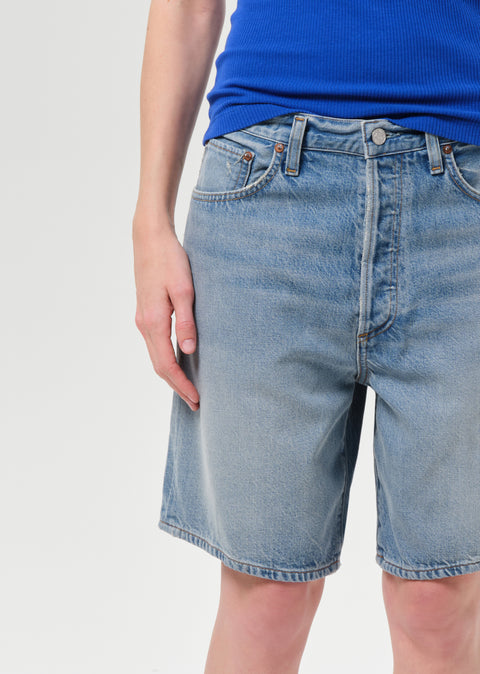 AGOLDE Indra Flyweight Short in Reset - Styled Shot of Women's Relaxed Medium Wash Denim Shorts