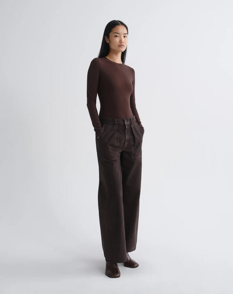 AGOLDE Low Curve Deep Roast Jean - Side View Highlighting Curved Tapered Leg and Utility Pocket on Rigid Regenerative Cotton Denim