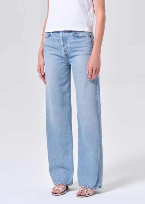 high-rise wide-leg silhouette, high waist, relaxed fit through hips.full-length 32-inch inseam for an elongated, polished look. Worn in light blue indigo wash
