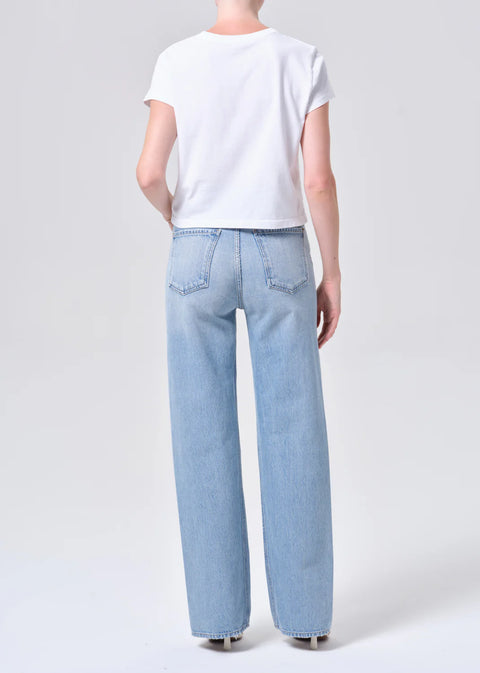 high-rise wide-leg silhouette, high waist, relaxed fit through hips.full-length 32-inch inseam for an elongated, polished look. Worn in light blue indigo wash
